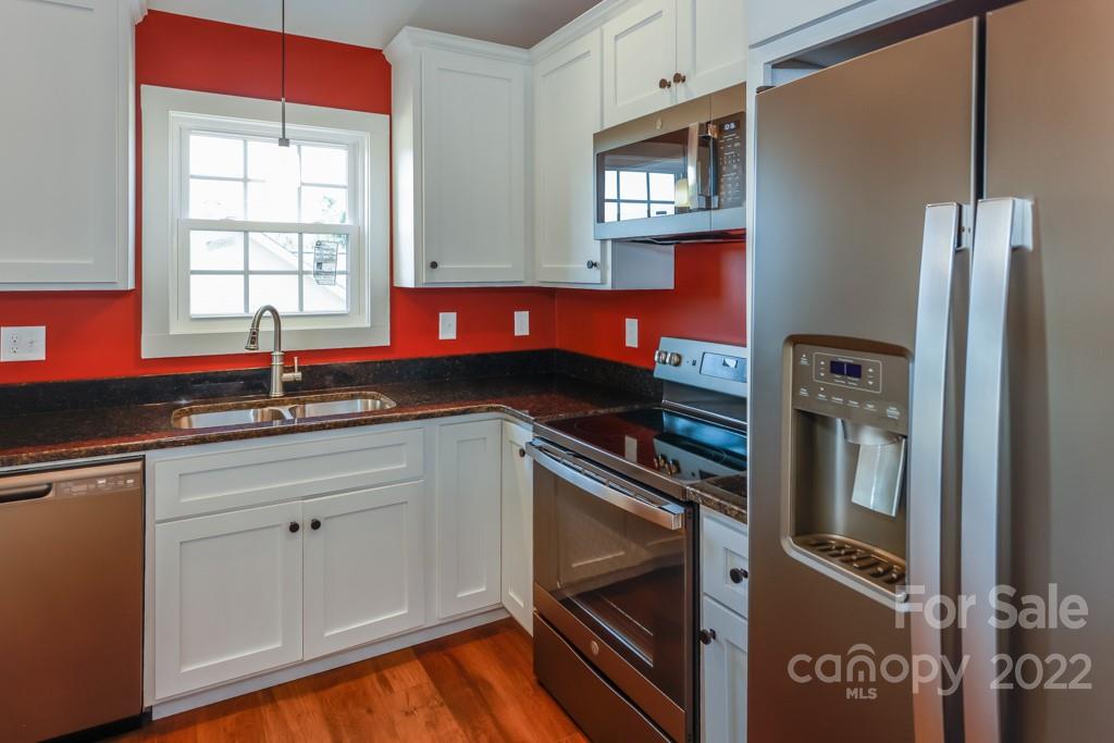 136 Augusta Drive Spindale, NC 28160 - Photo 5 of 19 a kitchen with stainless steel appliances granite countertop a sink and a refrigerator
