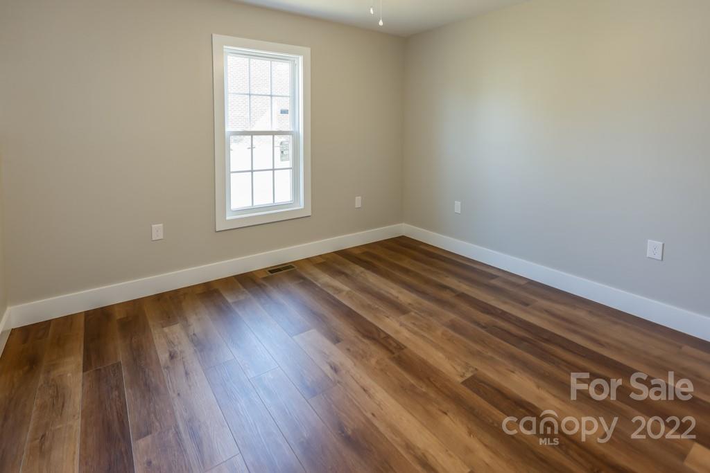 136 Augusta Drive Spindale, NC 28160 - Photo 10 of 19 a view of an empty room with wooden floor and a window