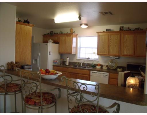 210 Oak Ridge Drive Corpus Christi, TX 78418 - Photo 2 of 10 a kitchen with a table chairs stove and cabinets