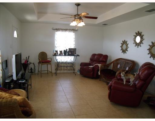 210 Oak Ridge Drive Corpus Christi, TX 78418 - Photo 4 of 10 a living room with furniture a chandelier and a window
