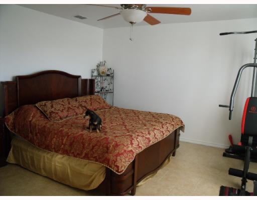 210 Oak Ridge Drive Corpus Christi, TX 78418 - Photo 5 of 10 a bed sitting in a bedroom next to a window