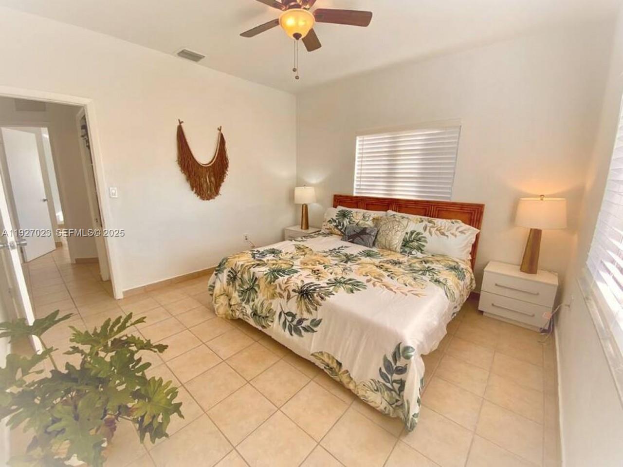 1872 Southwest 9th Street Miami, FL 33135 - Photo 12 of 48 a bedroom with a bed and a chandelier