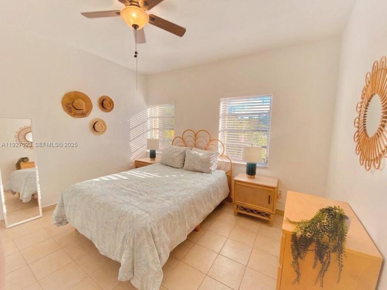 1872 Southwest 9th Street Miami, FL 33135 - Photo 15 of 48 a bedroom with a bed and a chandelier