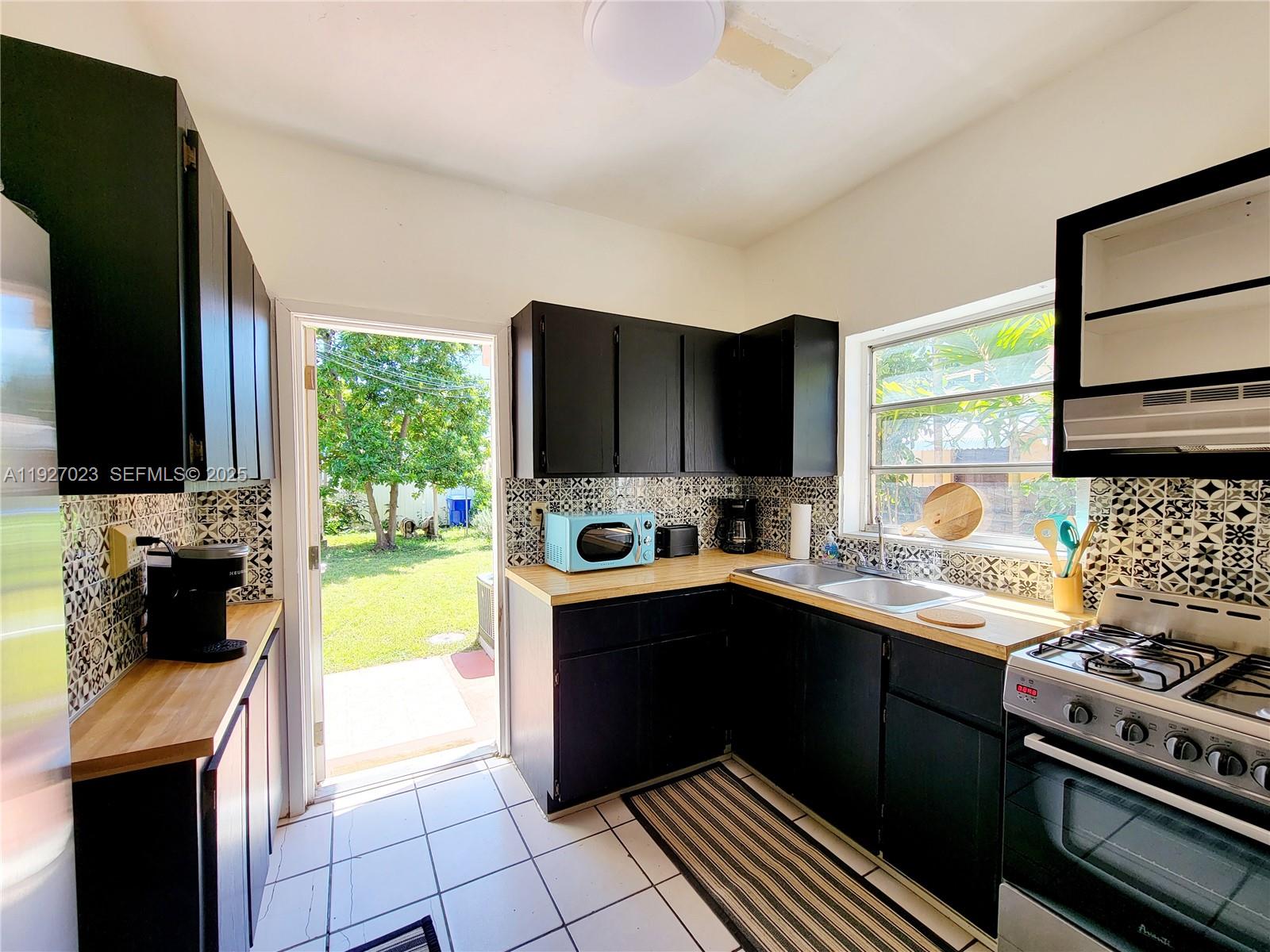 1872 Southwest 9th Street Miami, FL 33135 - Photo 20 of 48 a kitchen with a sink and a stove top oven