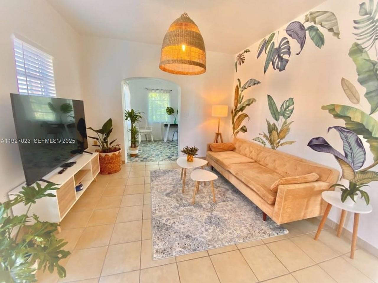 1872 Southwest 9th Street Miami, FL 33135 - Photo 2 of 48 a living room with a couch and a flat screen tv