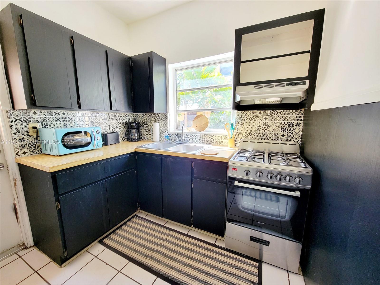 1872 Southwest 9th Street Miami, FL 33135 - Photo 21 of 48 a kitchen with a stove and a sink