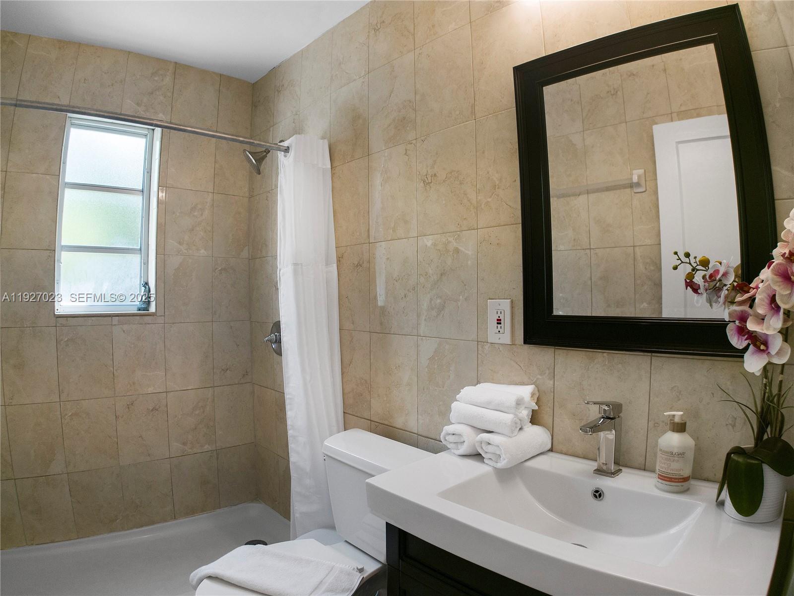 1872 Southwest 9th Street Miami, FL 33135 - Photo 25 of 48 a bathroom with a sink a toilet and mirror