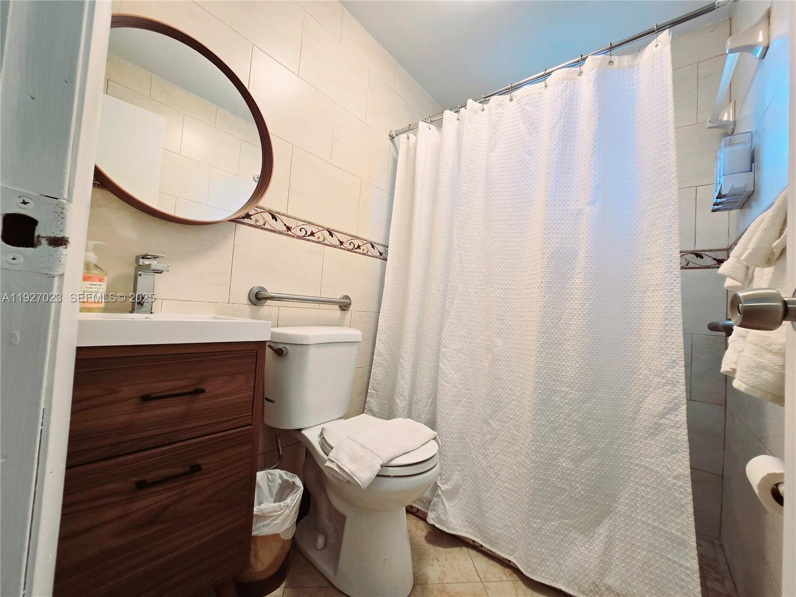 1872 Southwest 9th Street Miami, FL 33135 - Photo 39 of 48 a bathroom with a sink a toilet and shower curtain