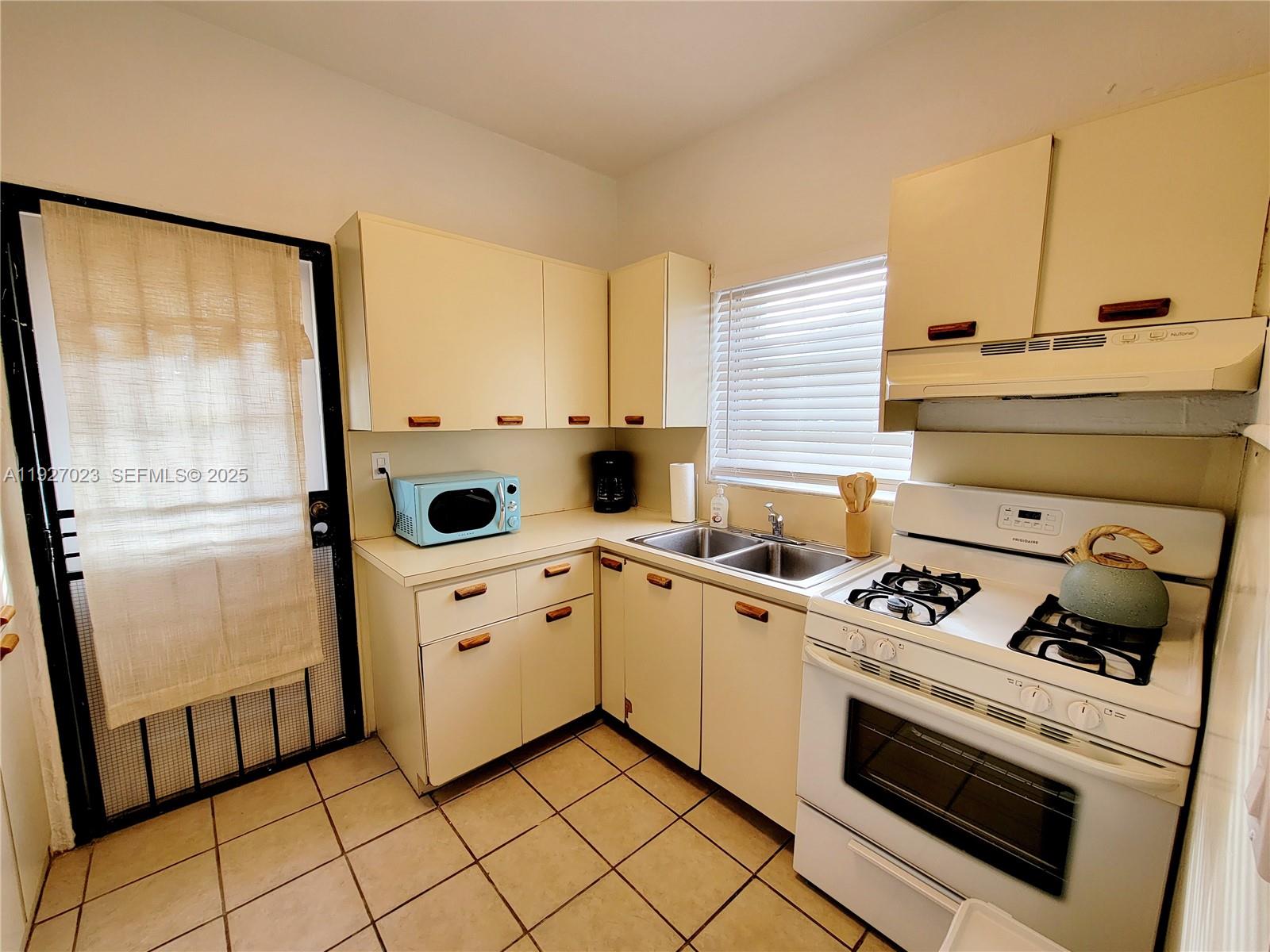 1872 Southwest 9th Street Miami, FL 33135 - Photo 5 of 48 a kitchen with a stove and white cabinets