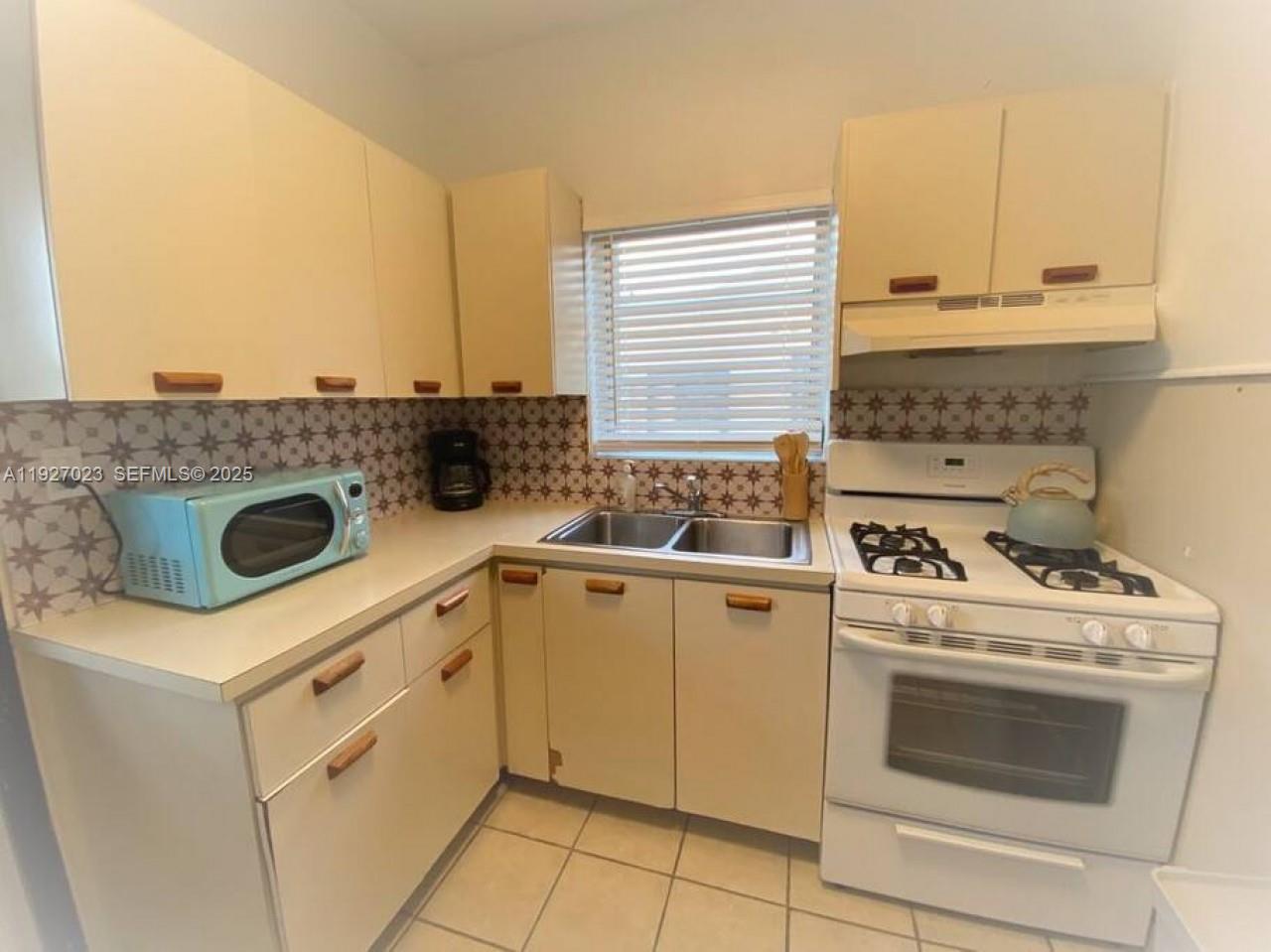 1872 Southwest 9th Street Miami, FL 33135 - Photo 9 of 48 a kitchen with a stove and a sink