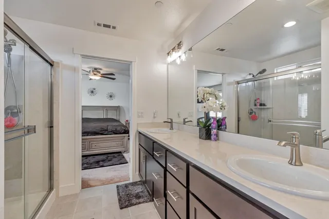a bathroom with a sink double vanity and a mirror