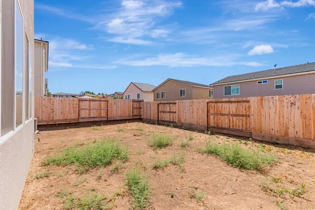 a view of a backyard of the house