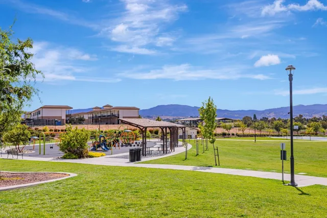 a view of a big house with a big yard and potted plants