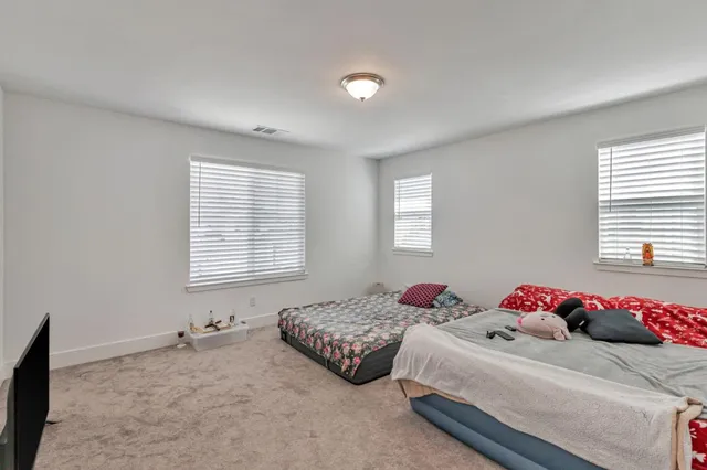 a bedroom with two bed and a window