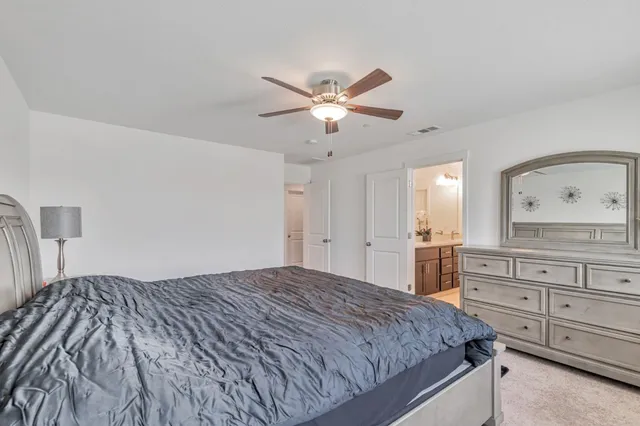 a bedroom with a bed and a dresser