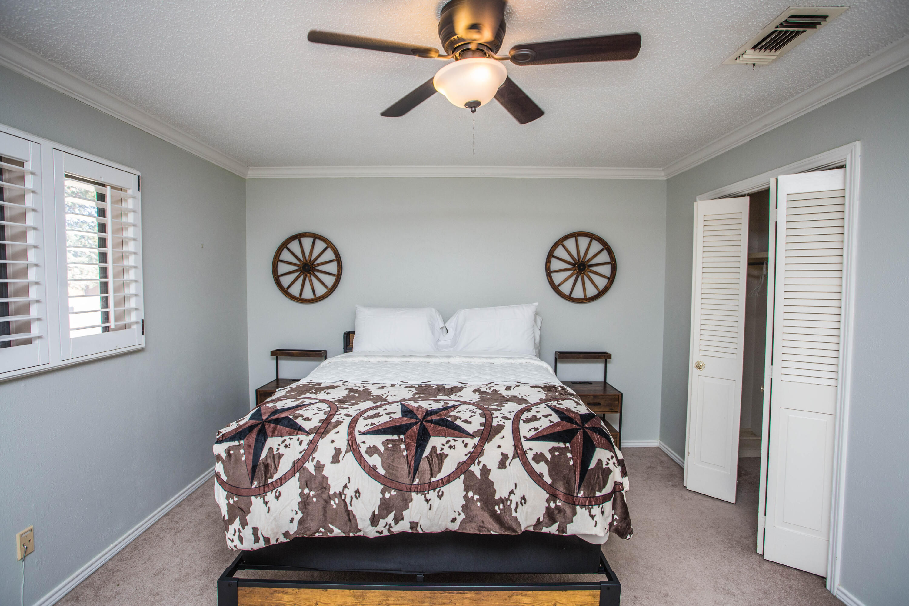 5407 79th Street Lubbock, TX 79424 - Photo 14 of 19 a bedroom with a bed and a chandelier