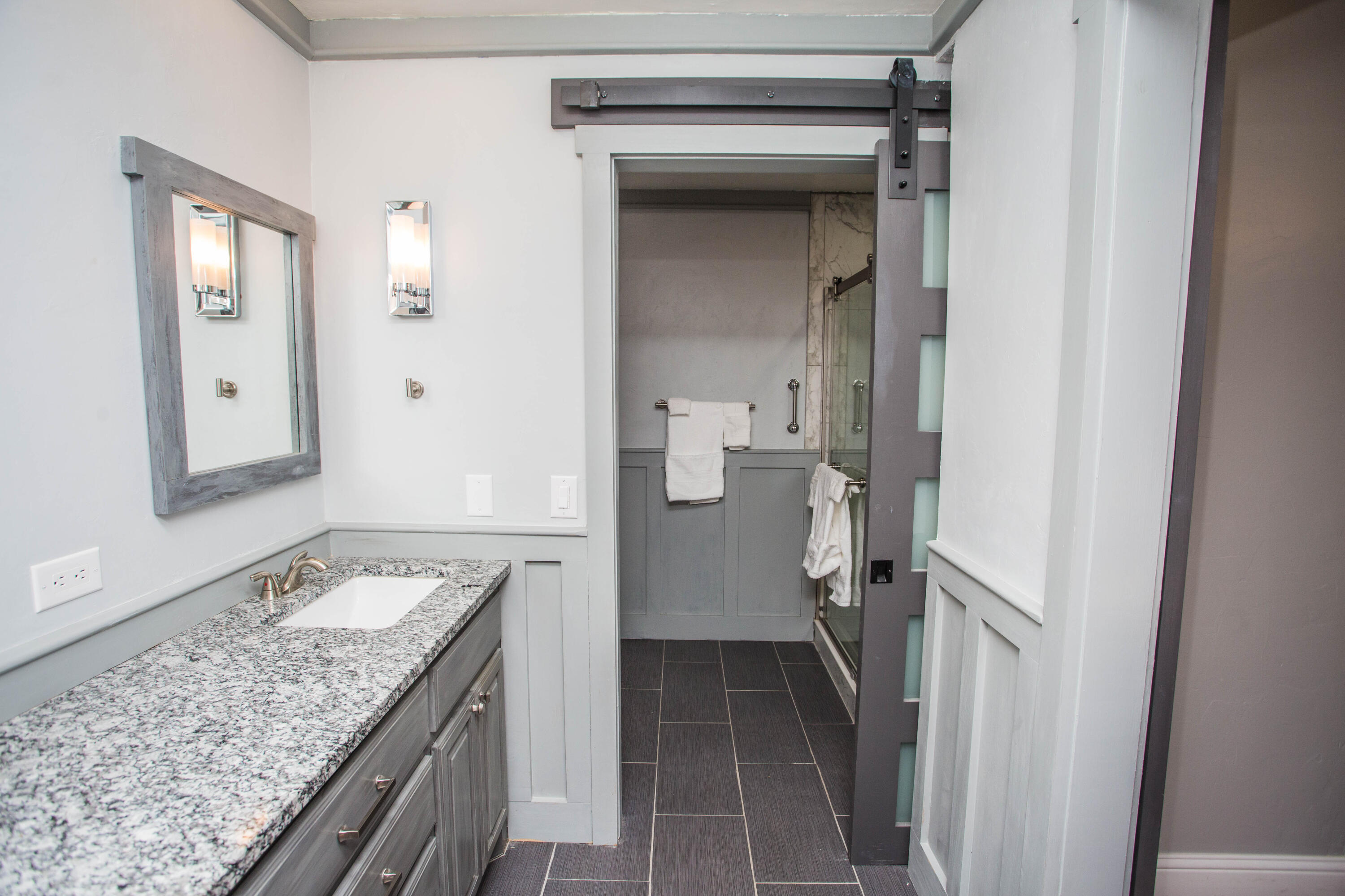 5407 79th Street Lubbock, TX 79424 - Photo 16 of 19 a bathroom with a granite countertop sink and a mirror