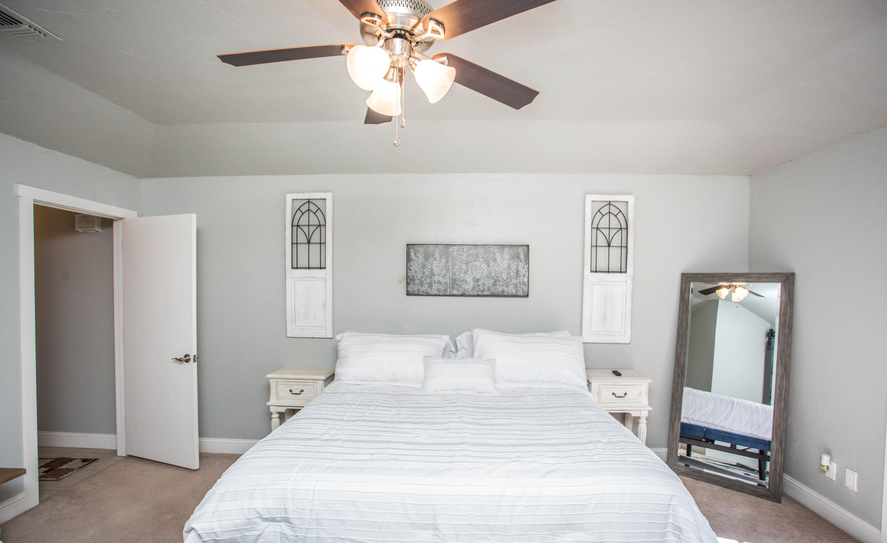 5407 79th Street Lubbock, TX 79424 - Photo 19 of 19 a bedroom with a bed and a chandelier