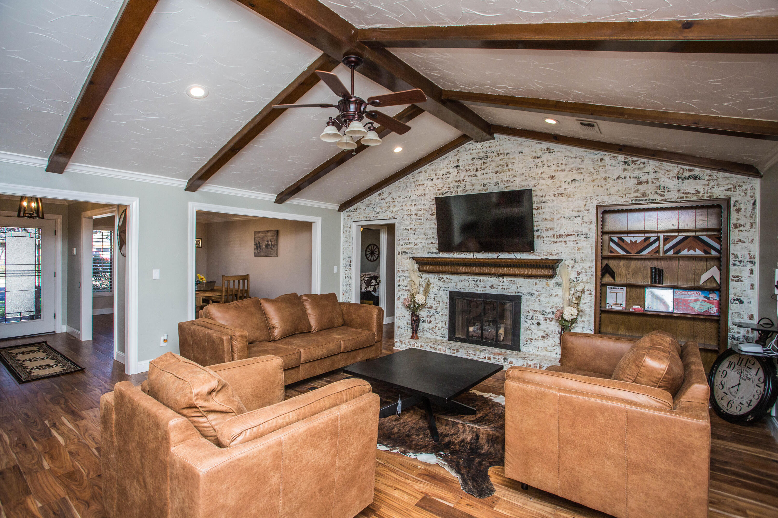 5407 79th Street Lubbock, TX 79424 - Photo 4 of 19 a living room with furniture a fireplace and a flat screen tv