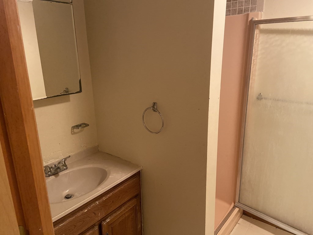 2 Fred Dolan Circle, Unit 2 Randolph, MA 02368 - Photo 22 of 25 a bathroom with a granite countertop sink and mirror with toilet