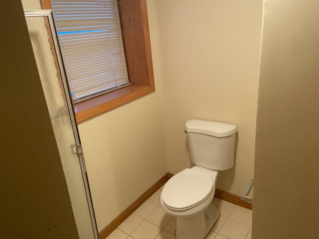 2 Fred Dolan Circle, Unit 2 Randolph, MA 02368 - Photo 23 of 25 a white toilet sitting next to a small window