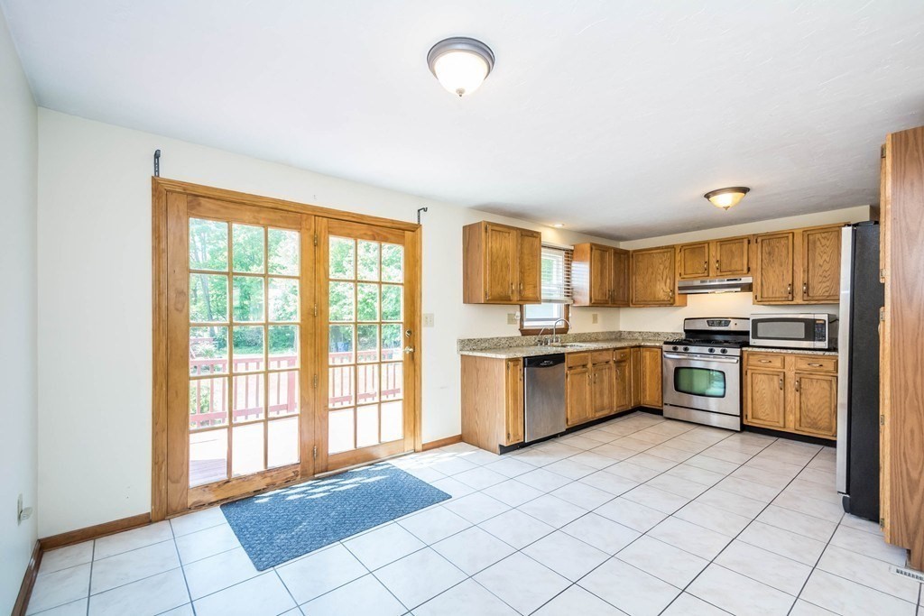 2 Fred Dolan Circle, Unit 2 Randolph, MA 02368 - Photo 5 of 25 a large kitchen with a stove top oven sink and cabinets