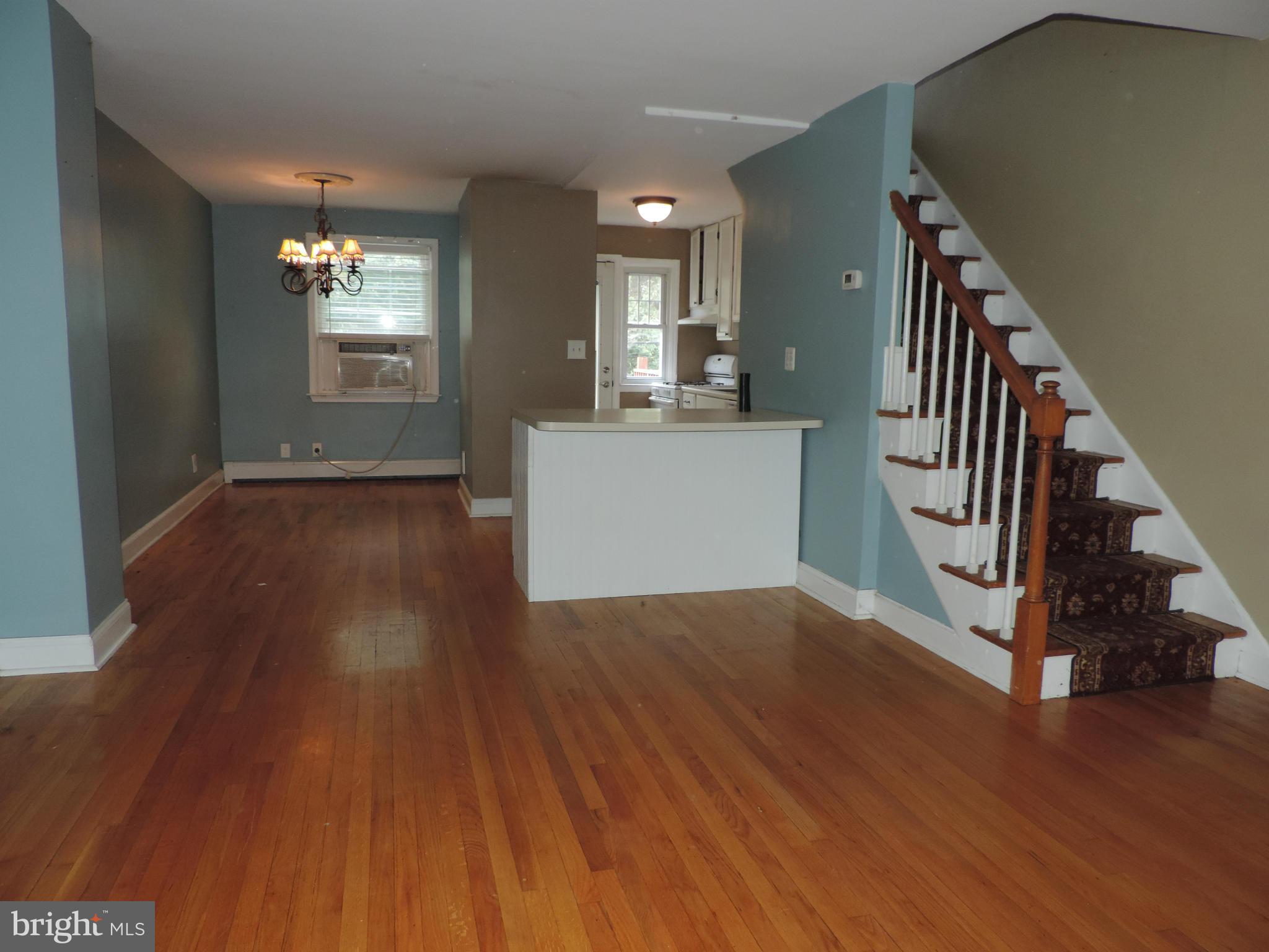1124 Elm Road Baltimore, MD 21227 - Photo 3 of 13 a view of a hallway with wooden floor and staircase