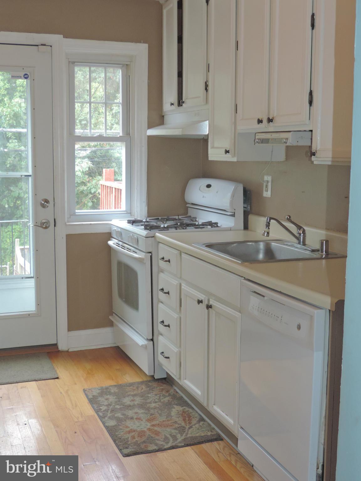 1124 Elm Road Baltimore, MD 21227 - Photo 6 of 13 a kitchen with stainless steel appliances granite countertop a sink stove and cabinets