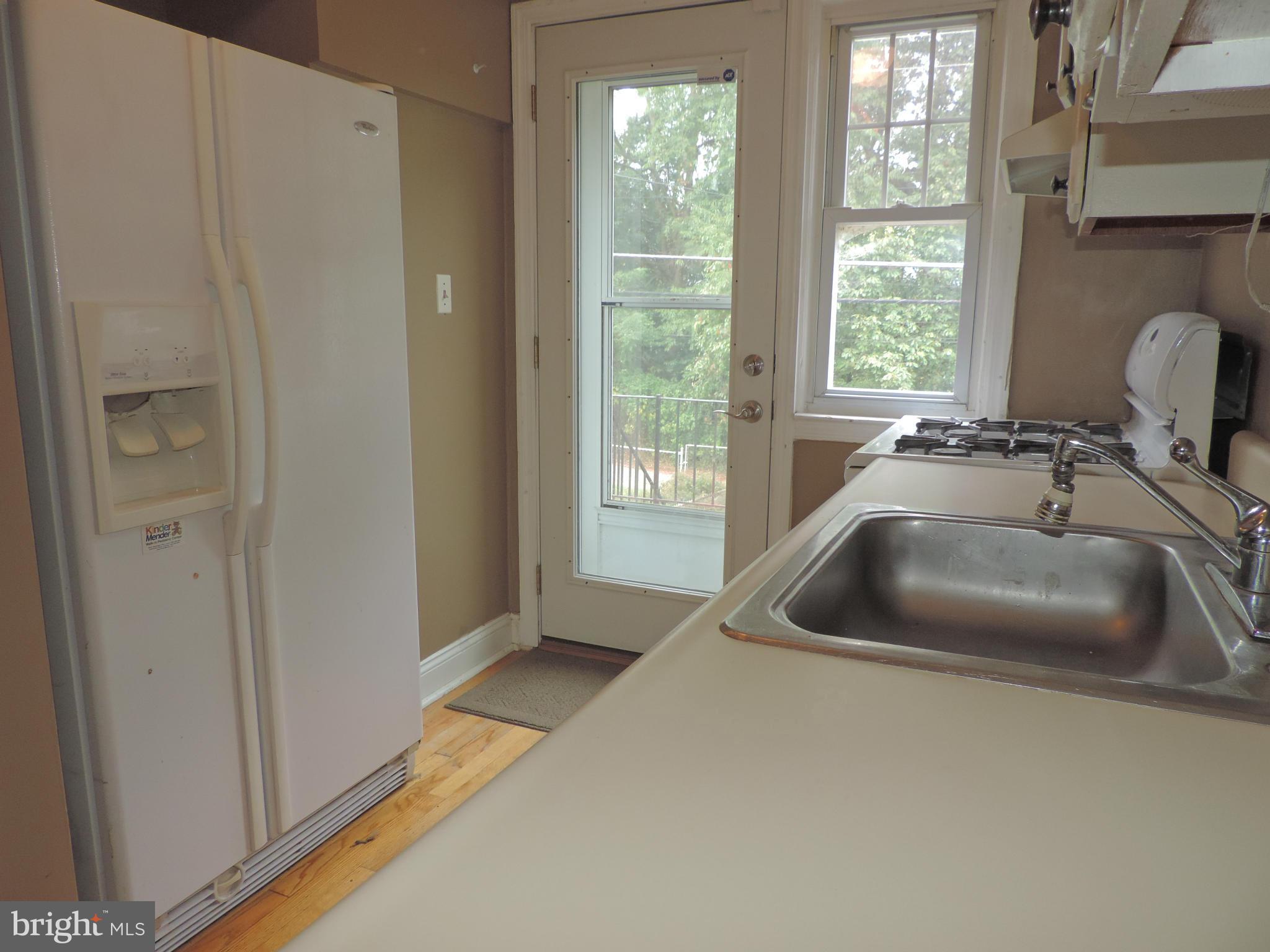 1124 Elm Road Baltimore, MD 21227 - Photo 7 of 13 a kitchen with a sink and a large window