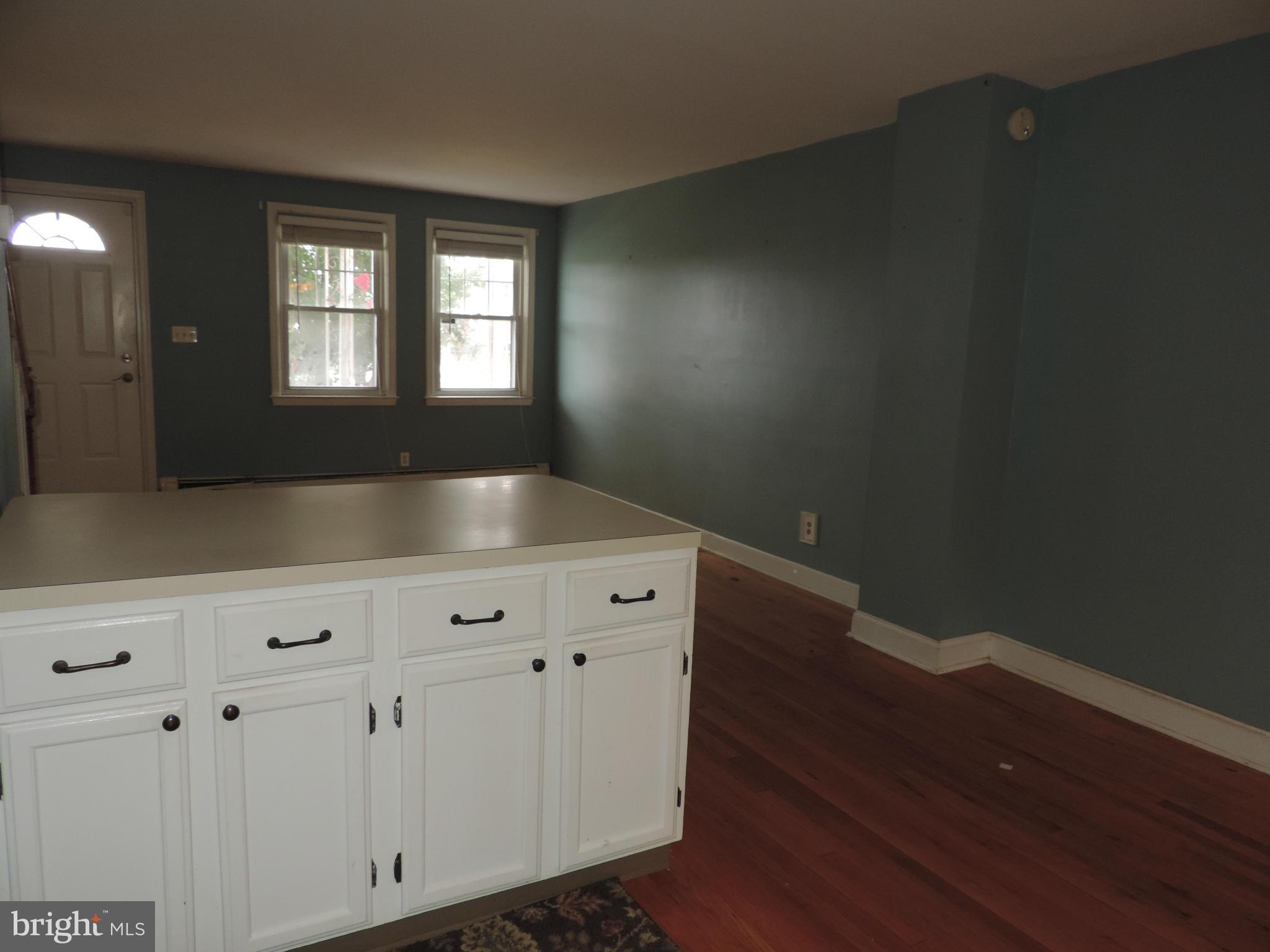 1124 Elm Road Baltimore, MD 21227 - Photo 8 of 13 a view of an empty room with window
