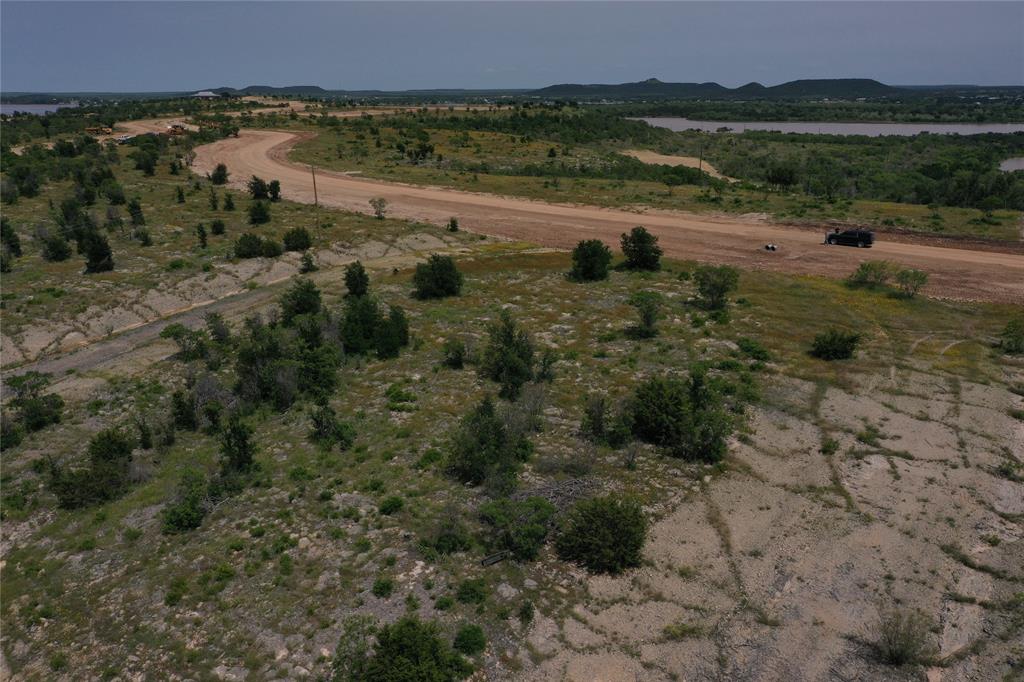 Lot 126 White Moon Road Graham, TX 76450 - Photo 11 of 40 a view of a lake with green field and mountains