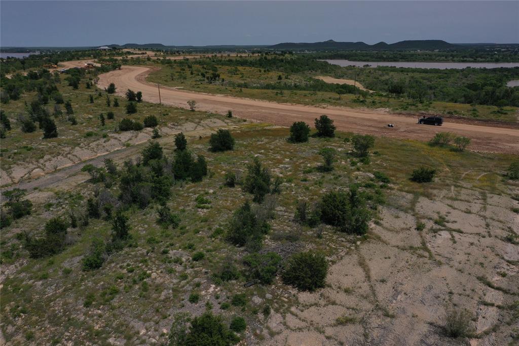 Lot 126 White Moon Road Graham, TX 76450 - Photo 23 of 40 a view of a lake with green field and mountains