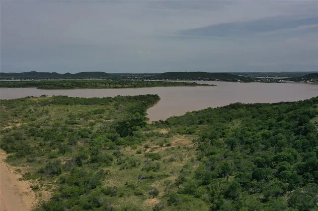 a view of a lake with houses in the back
