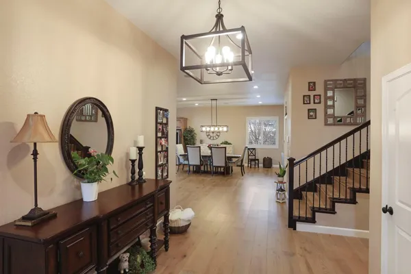 a dining room with stainless steel appliances kitchen island granite countertop a table and chairs