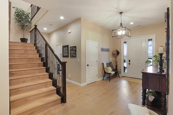 a dining room with furniture and wooden floor
