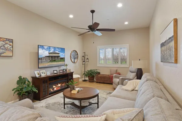 a living room with furniture and a ceiling fan