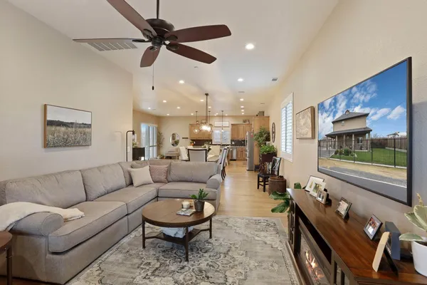 a living room with furniture and wooden floor