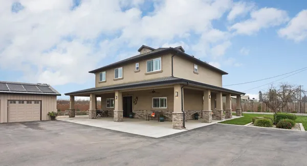 a view of a livingroom with furniture wooden floor and windows