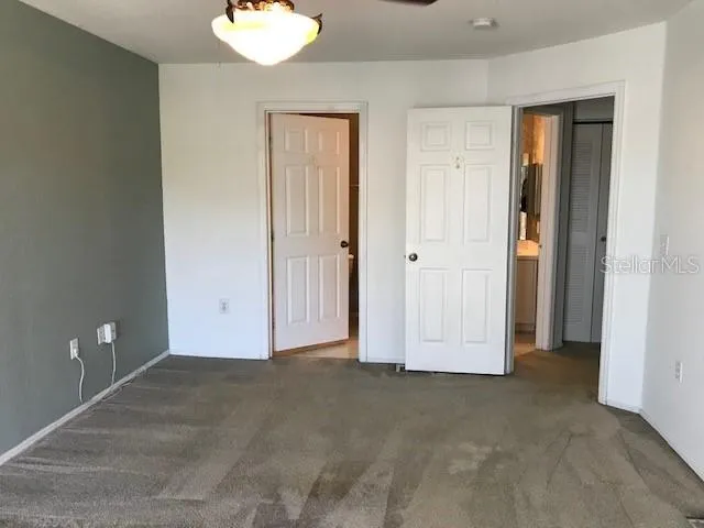 an empty room with closet area