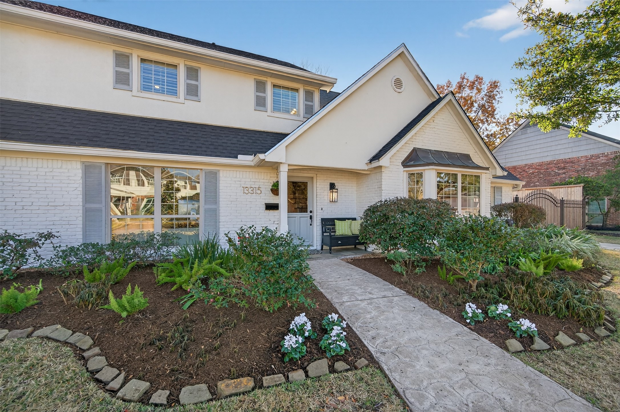 13315 Tosca Lane Houston, TX 77079 - Photo 2 of 42 a front view of a house with garden
