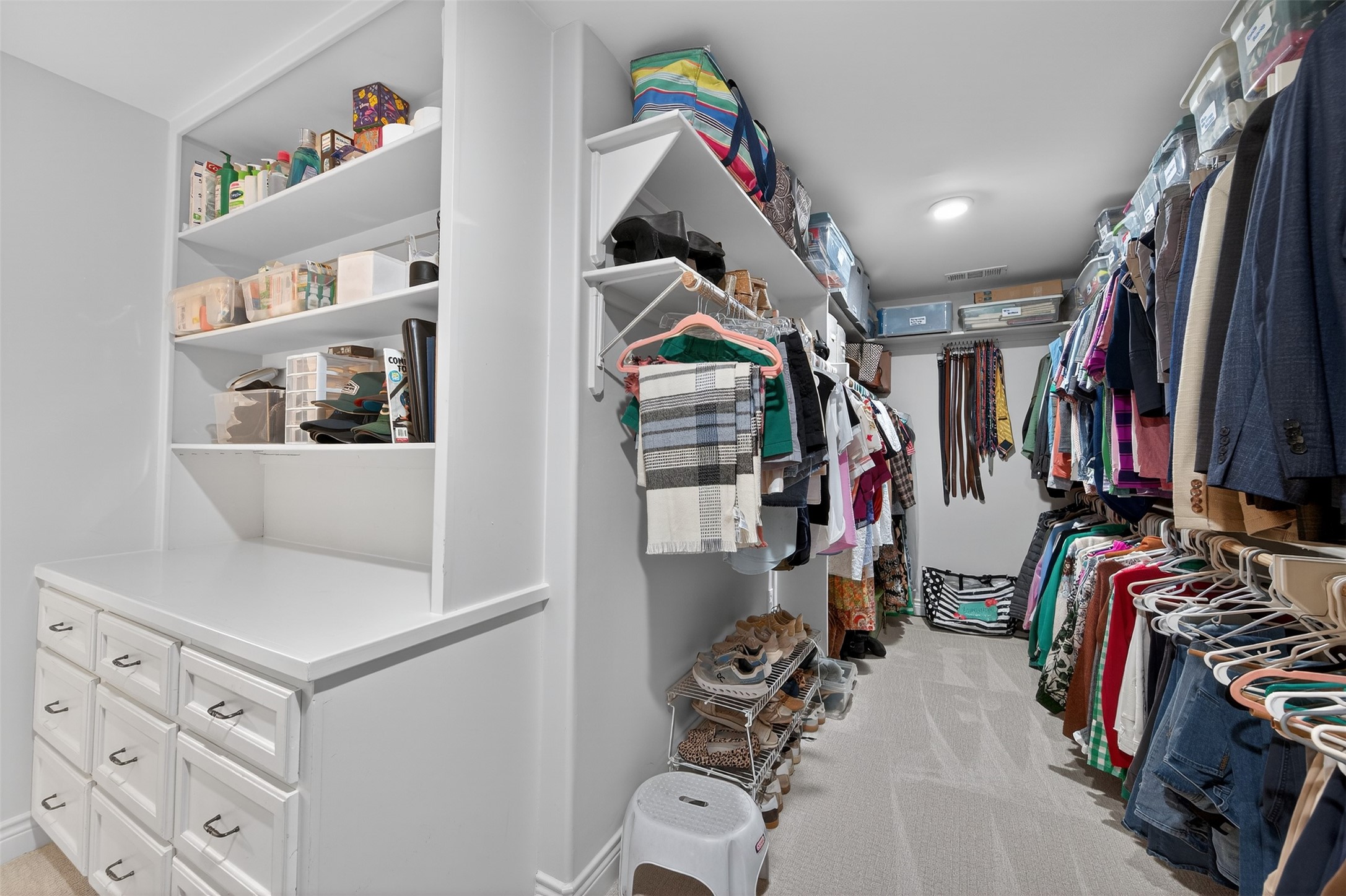13315 Tosca Lane Houston, TX 77079 - Photo 25 of 42 a view of walk in closet with clothes and shoes
