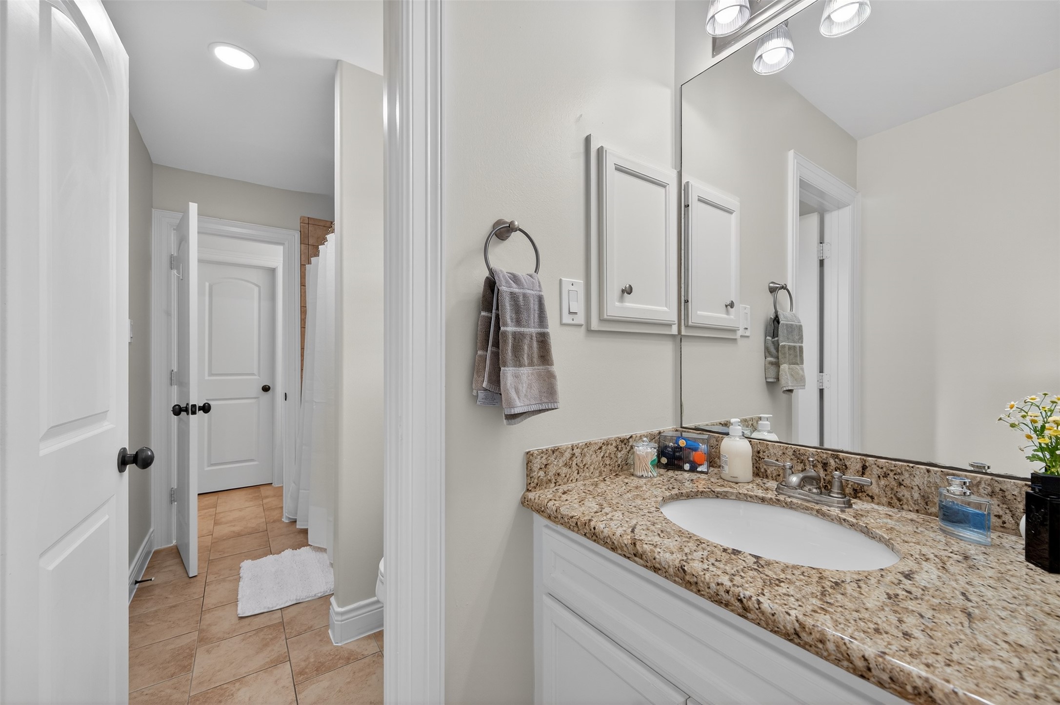 13315 Tosca Lane Houston, TX 77079 - Photo 30 of 42 a bathroom with a granite countertop sink and a mirror