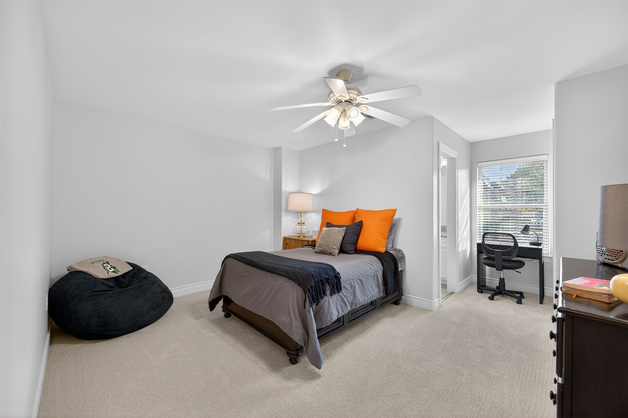 13315 Tosca Lane Houston, TX 77079 - Photo 31 of 42 a bedroom with a bed and a chandelier