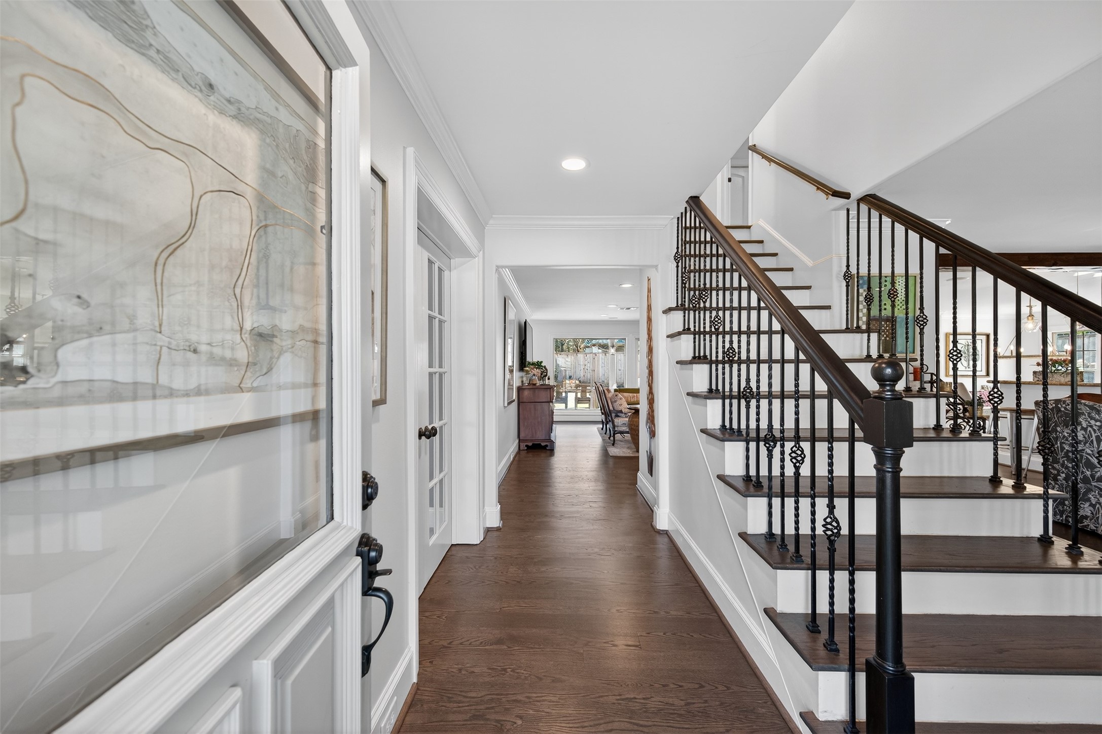 13315 Tosca Lane Houston, TX 77079 - Photo 4 of 42 a view of a hallway with wooden floor and staircase