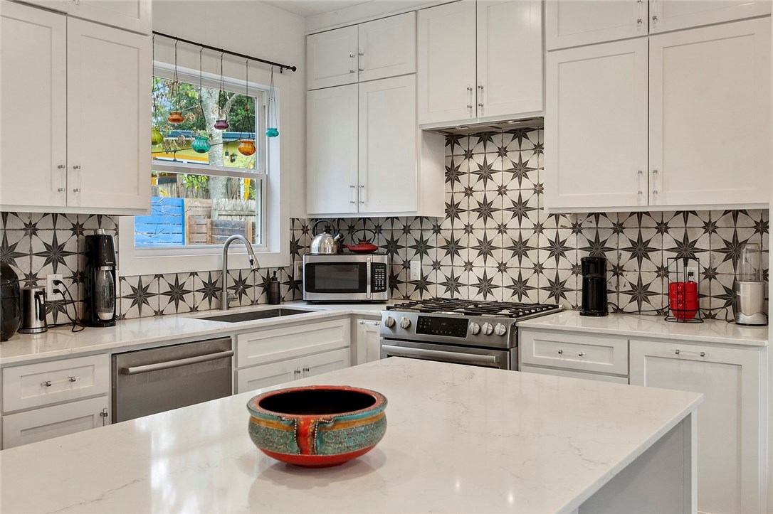 401 Post Rd Drive Austin, TX 78704 - Photo 1 of 1 a kitchen with stainless steel appliances a stove a sink and white cabinets