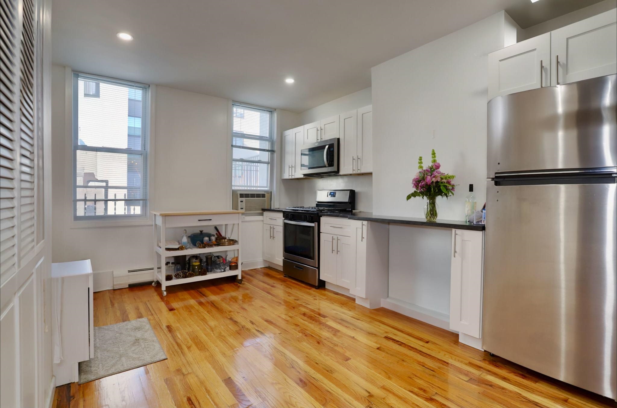 402 Monroe Street, Unit 2 Hoboken, NJ 07030 - Photo 2 of 22 a kitchen with stainless steel appliances a refrigerator sink and wooden floor
