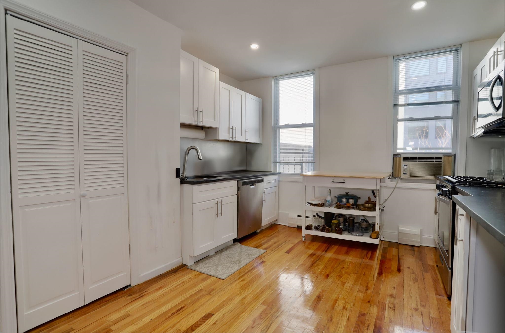 402 Monroe Street, Unit 2 Hoboken, NJ 07030 - Photo 3 of 22 a kitchen with a refrigerator and a stove top oven