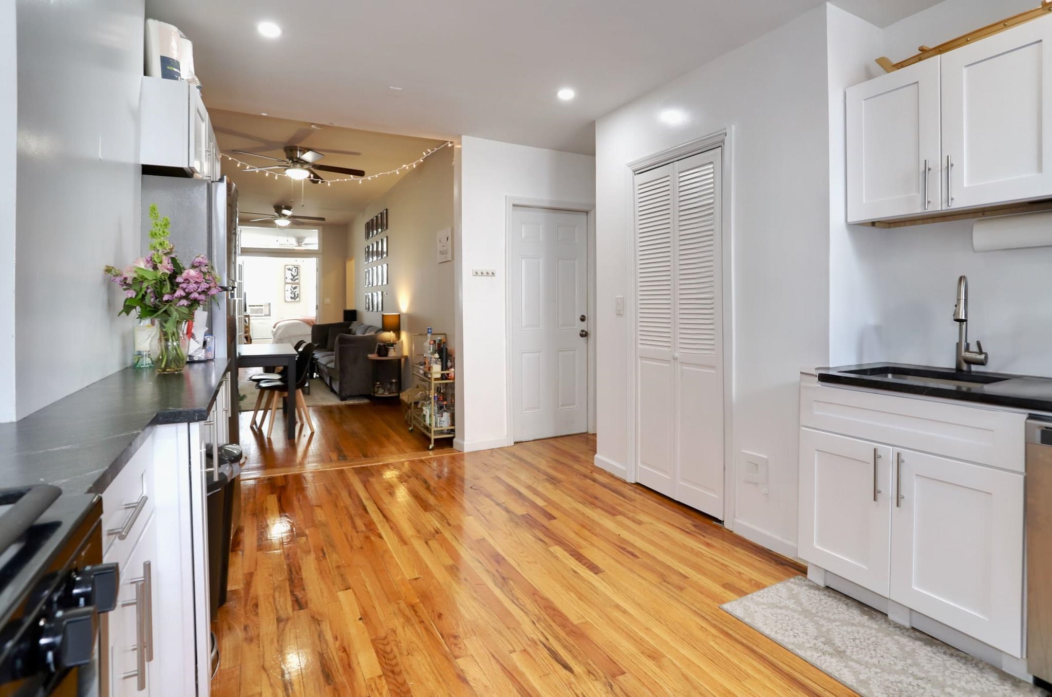 402 Monroe Street, Unit 2 Hoboken, NJ 07030 - Photo 5 of 22 a view of dining room kitchen with stainless steel appliances granite countertop a stove a sink a refrigerator and cabinets