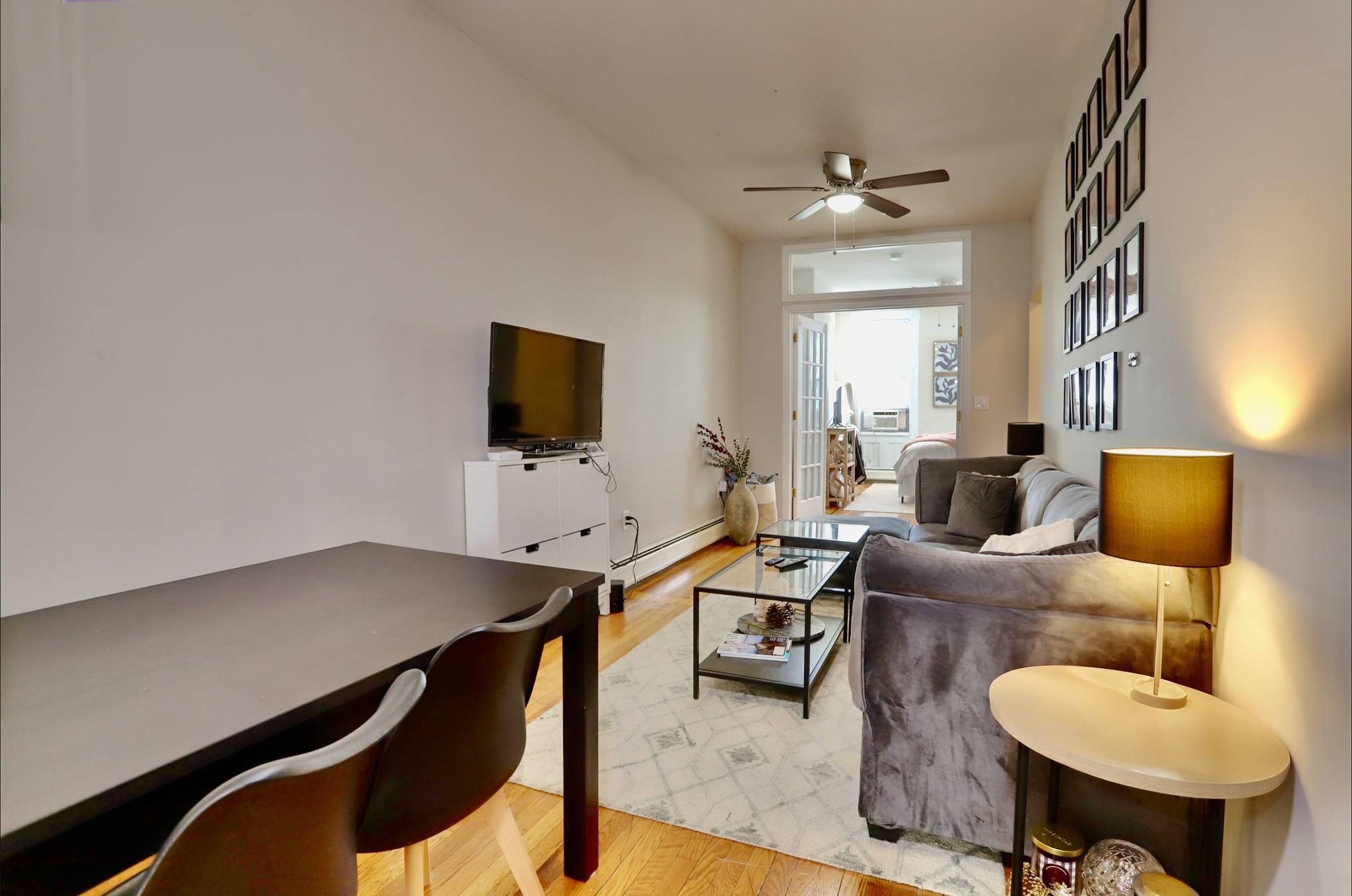 402 Monroe Street, Unit 2 Hoboken, NJ 07030 - Photo 6 of 22 a living room with furniture and a flat screen tv