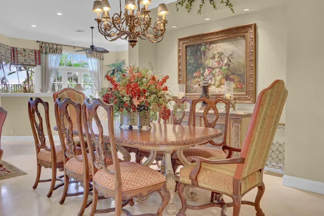 a view of a dining room with furniture and chandelier